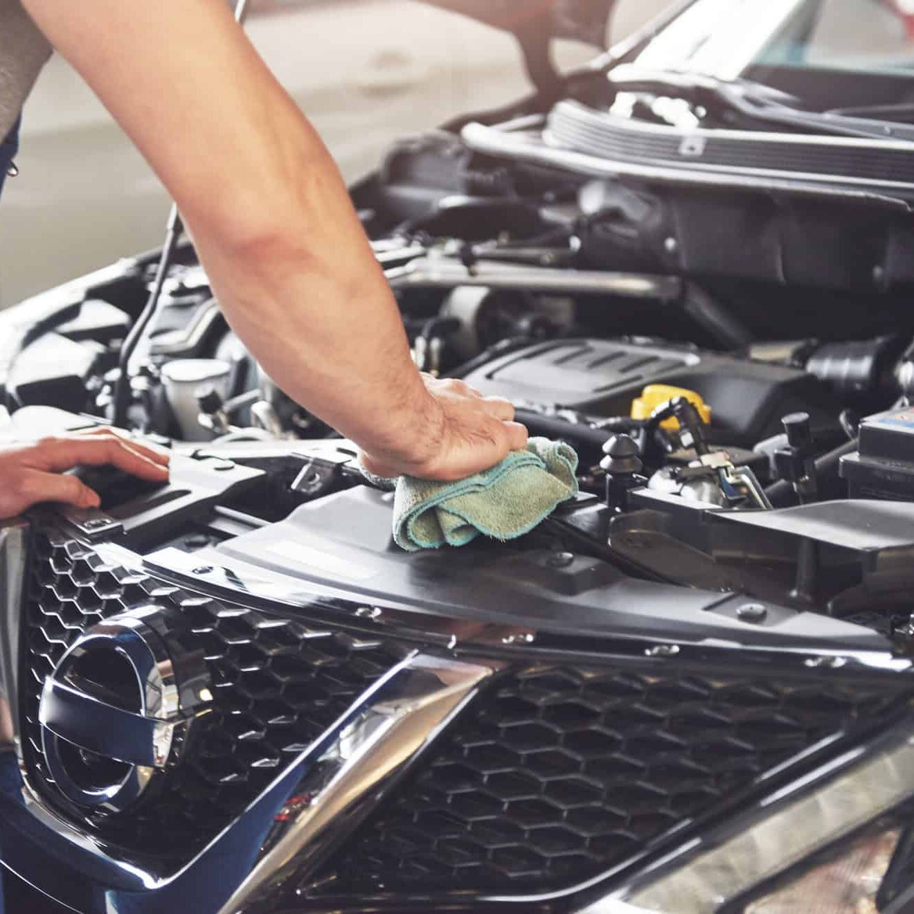 muscular-car-service-worker-repairing-vehicle